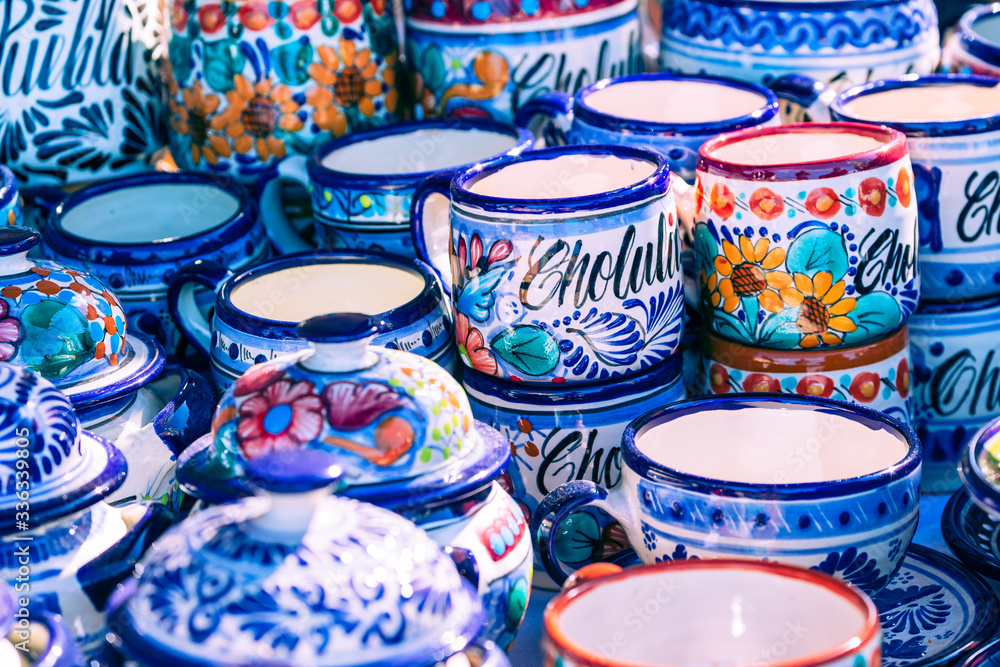 Colorful traditional Mexican pottery. Talavera style. Souvenirs on sale in local market of Cholula, Mexico.
