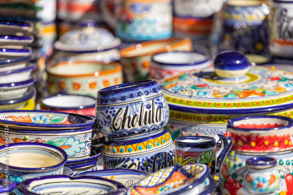 Colorful traditional Mexican pottery. Talavera style. Souvenirs on sale in local market of Cholula, Mexico.