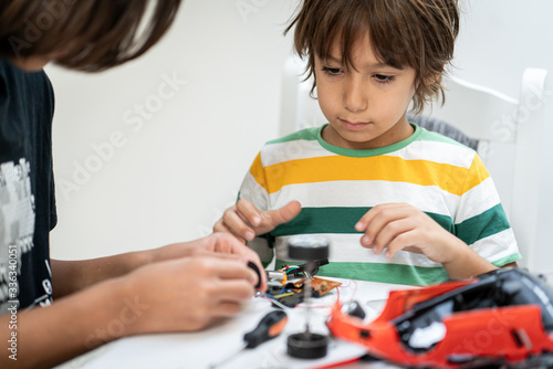 Kids building robot at robotic technology school lesson