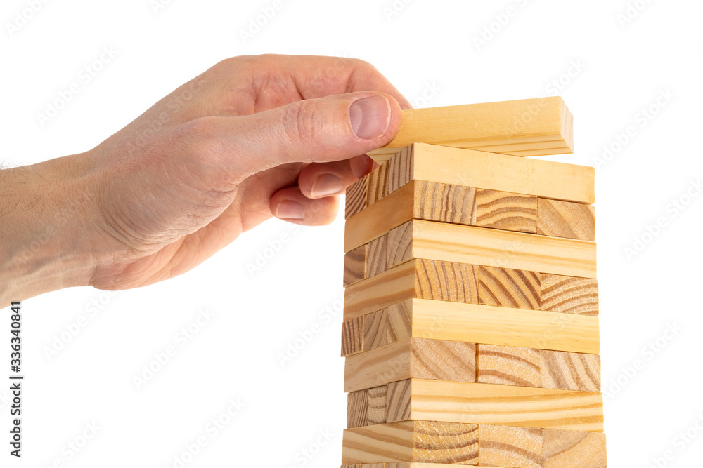 Businessman making a pyramid with wooden cubes Businessman making a pyramid with wooden cubes