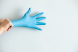 Код стоковой фотографии без лицензионных платежей: 1695500611
Blue medical gloves on the white background. Coronavirus rules .
