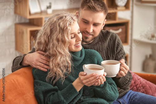 Happy young couple drinking...