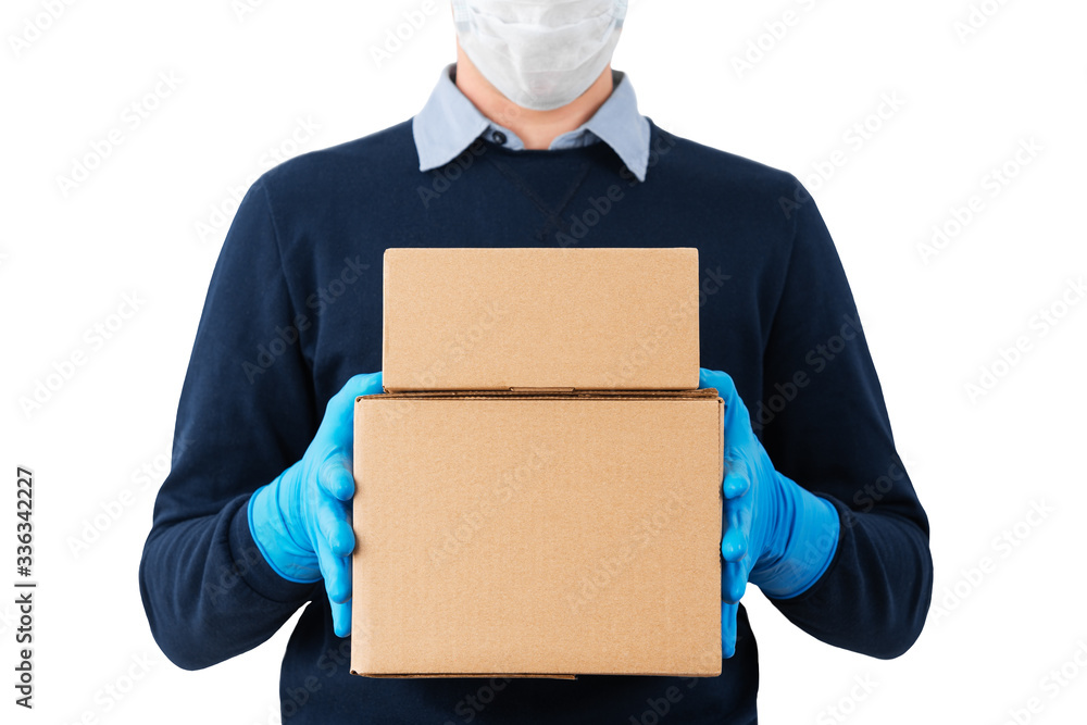 Contact less delivery concept, touch free shipment, courier in a protective mask and rubber gloves with carboard box , safe order from online shop Contact less delivery concept, touch free shipment, courier in a protective mask and rubber gloves with carboard box , safe order from online shop