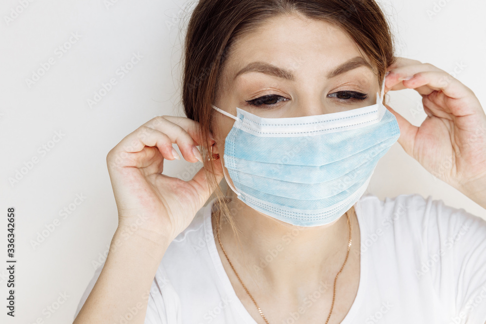 Portrait of young woman wearing medical face mask . Stop coronavirus .  Covid-19 Pandemic of yhe world 