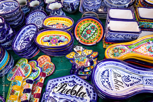 Colorful traditional Mexican pottery. Talavera style. Souvenirs on sale in local market of Puebla, Mexico.