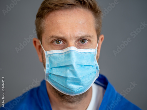 Male Doctor or Nurse Wearing Protective face medical Mask. Save lives from Covid-19 Outbreak