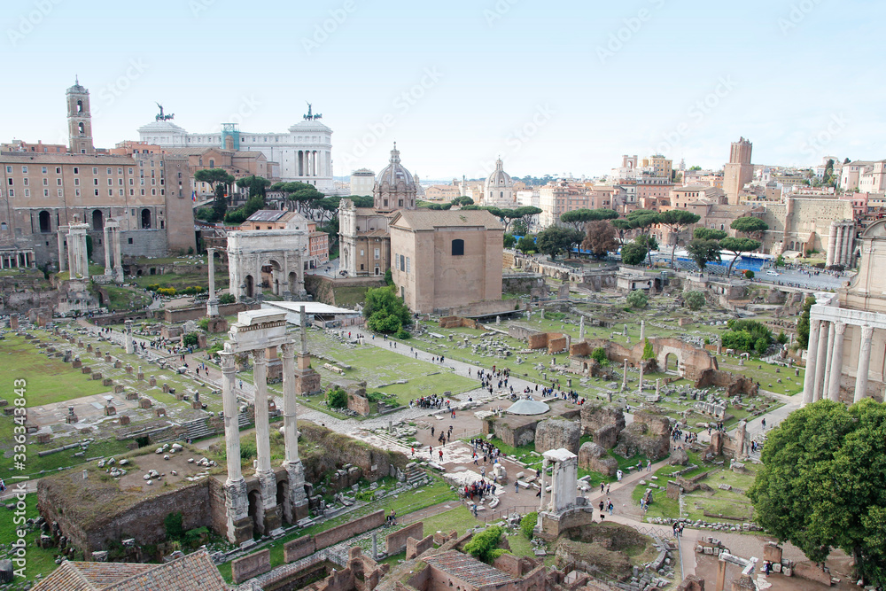 Aerial panoramic cityscape view of the Roman Forum during sunset in Rome, Italy