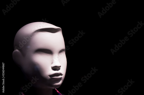 Child mannequin portrait on dark background without expression