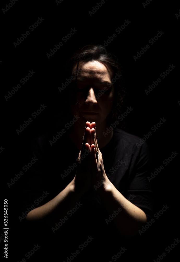 Woman standing in prayer