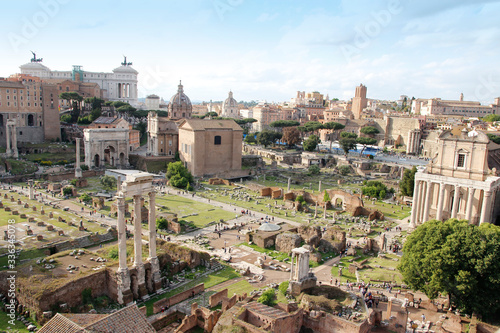 Aerial panoramic cityscape view of the Roman Forum and Roman Colosseum during sunset in Rome, Italy