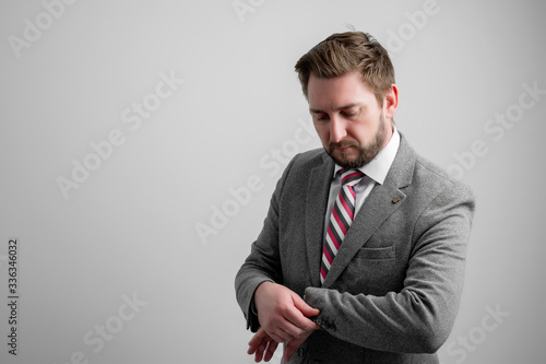 Portrait of business man arranging his business jacket