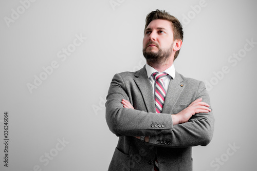 Portrait of business man wearing business clothes standing with arms crossed
