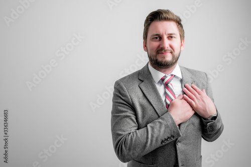 Portrait of business man wearing business clothes keep hands near heart
