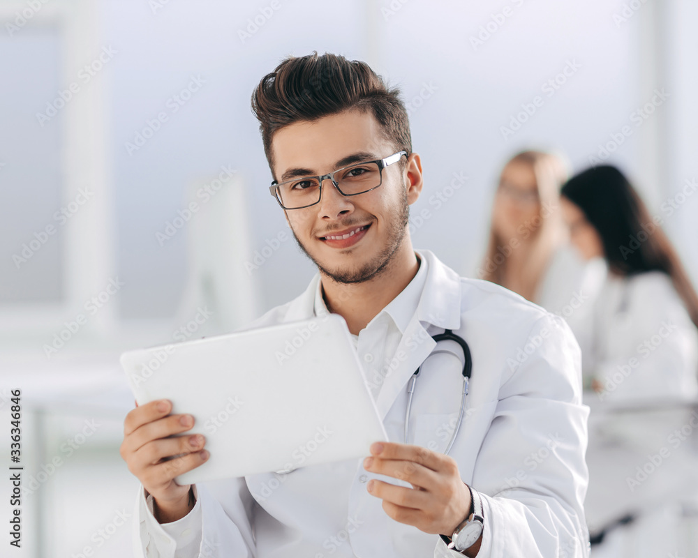 smiling doctor looking at the digital tablet screen smiling doctor looking at the digital tablet screen
