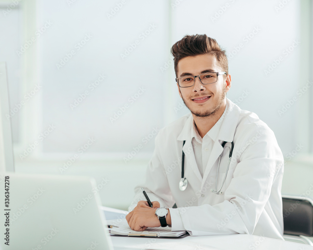 doctor therapist sitting at a table in his office doctor therapist sitting at a table in his office