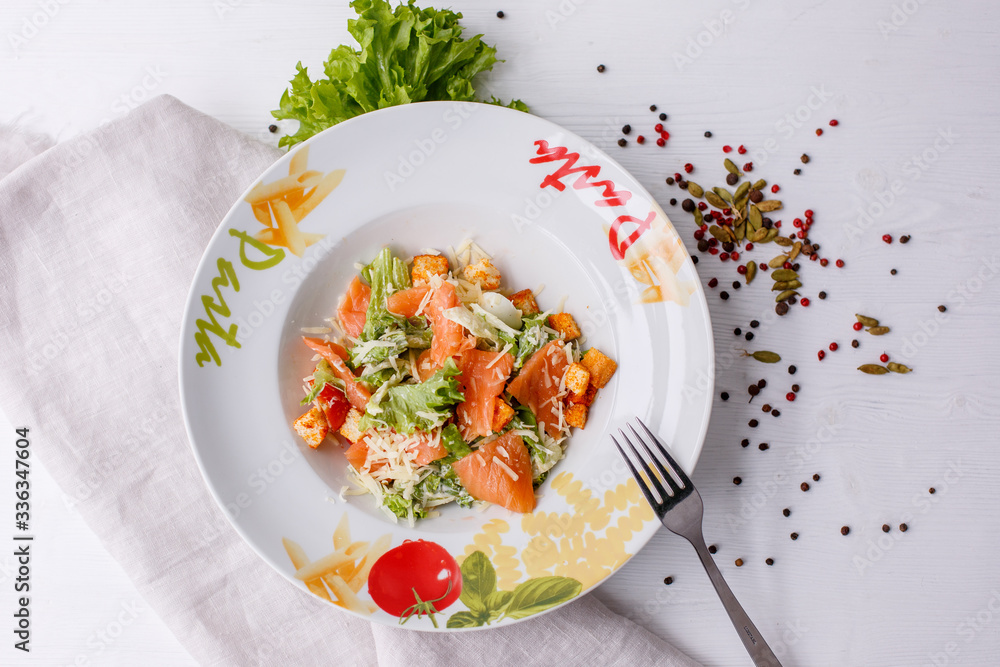 Caesar salad with salmon salad leaves on a light background, menu Caesar salad with salmon salad leaves on a light background, menu