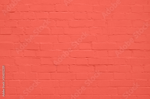 texture: old cracked brick wall painted in coral paint