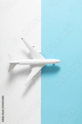 White model plane. Airplane on pastel blue and white background. Travel vacation concept. Flat lay, top view, copy space