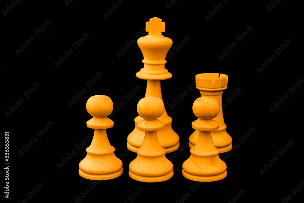 Castling. A special move in the game of Chess to protect the King behind pawns and with rook. Standard chess wooden pieces on black background Castling. A special move in the game of Chess to protect the King behind pawns and with rook. Standard chess wooden pieces on black background