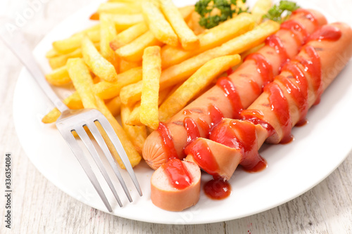 french fries and sausage in plate