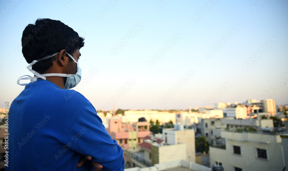 Masked man looking out with a hope Masked man looking out with a hope