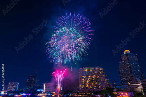 Beautiful firework display for celebration happy new year and merry christmas with Twilight night and firework lighting in bangkok cityscape background, Thailand.