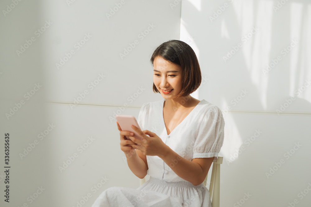 Pretty young lady looking at camera and standing at wall Pretty young lady looking at camera and standing at wall