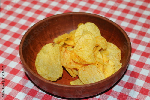 Crisps on a plate on a checkered tablecloth in a cafe