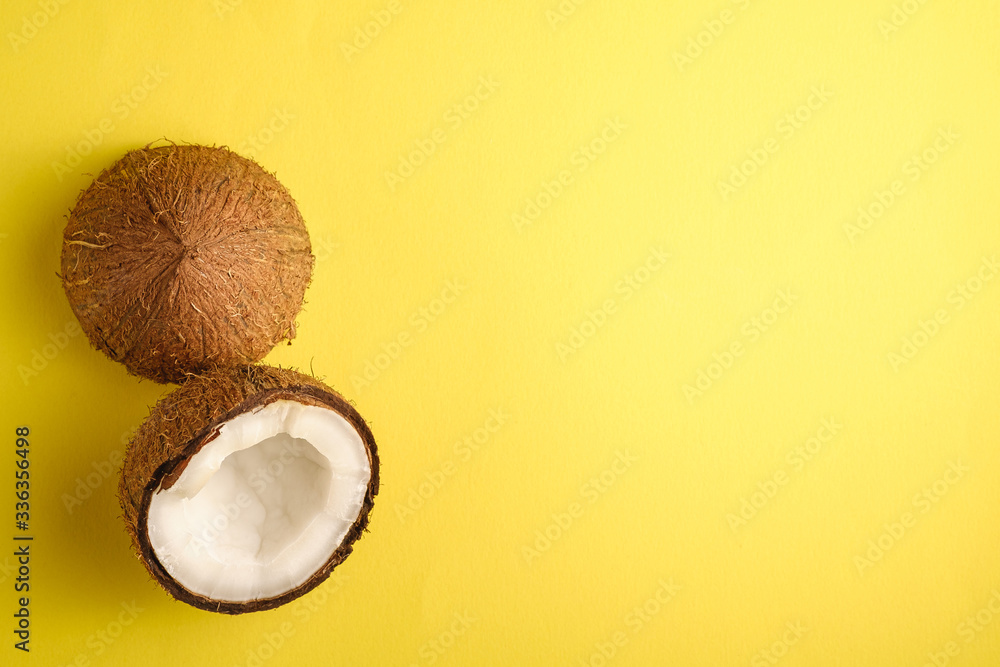 Coconut fruits on yellow plain background, abstract food tropical concept, top view copy space