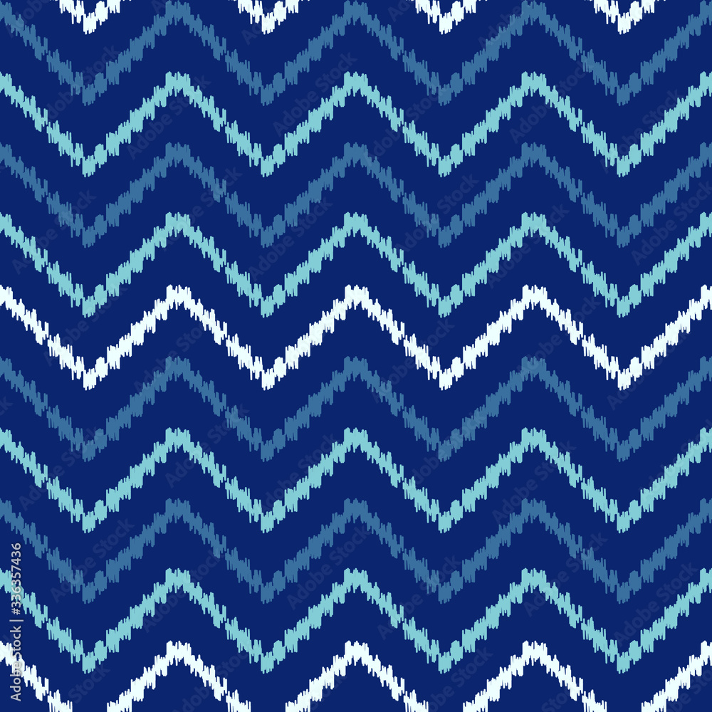 Abstract chevron Ikat geometric seamless pattern. Blue scribble zigzag waves on dark background. Ethnic asian, indian, aztec fashion style. Fancy boho texture for fabric print, wallpaper, gift wrap.