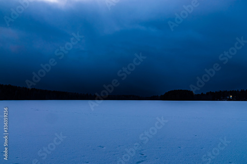 night landscape with a frozen lake and sky tightened clouds © Semiglass