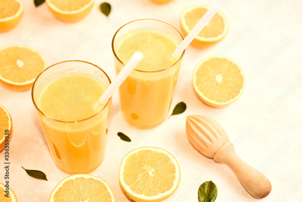 freshly squeezed orange juice in glasses on the kitchen table with slices of oranges, concept of diet and healthy lifestyle freshly squeezed orange juice in glasses on the kitchen table with slices of oranges, concept of diet and healthy lifestyle