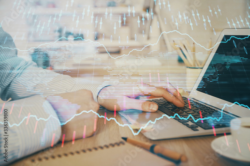 Multi exposure of stock market chart with man working on computer on background. Concept of financial analysis.