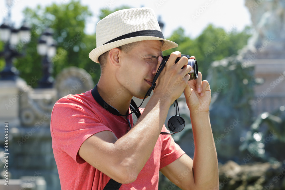 young male tourist taking picture
