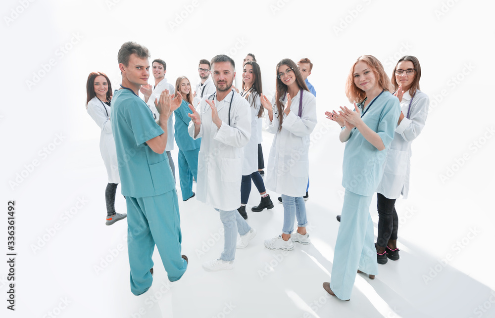 team of diverse doctors applauding their joint success team of diverse doctors applauding their joint success