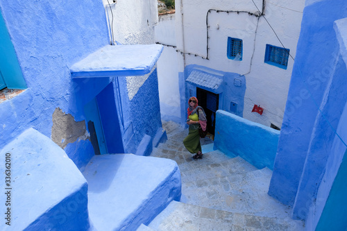 Alone female tourist traveling in the kasbah - old part of city Chefchaouen, Morocco © leospek
