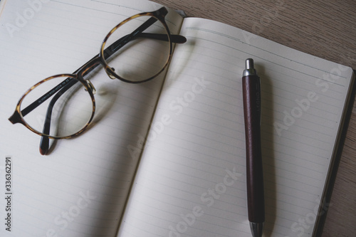 notepad and pen and glasses