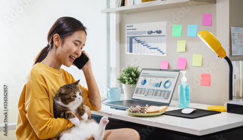 Canvas Print Young Asian woman working from home due to coronavirus covid-19, lifestyle worki