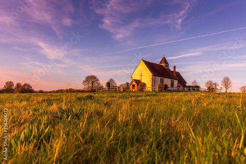 The Isolated St Hubert's Church, surrounded by fields on the South Downs National Park, Idsworth, Hampshire, UK