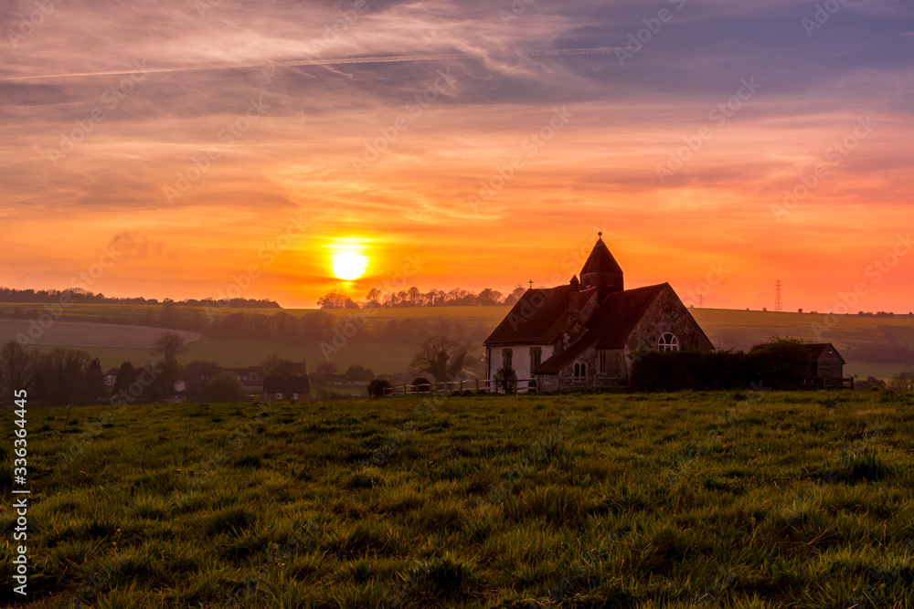 Sunset over the South Downs National Park at Idsworth with the ioslated  St Hubert's church, Hampshire, UK