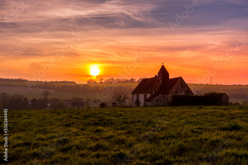 Obraz na płótnie Sunset over the South Downs National Park at Idsworth with the ioslated St Hubert's church, Hampshire, UK w salonie