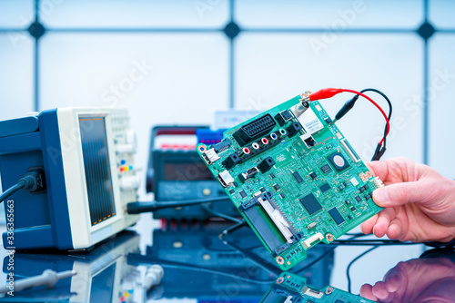Obraz na płótnie Debugging electronics device. PCB witch microcontroller in electronics laboratory