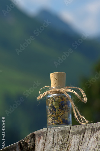 glass bottle with dried mountain herbs
