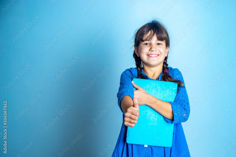 indoor portrait of young child girl with laptop, isolated studio shot, online education indoor portrait of young child girl with laptop, isolated studio shot, online education
