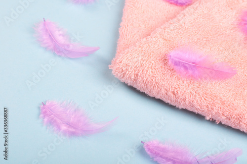 Feathers with towel on backgorund composition.