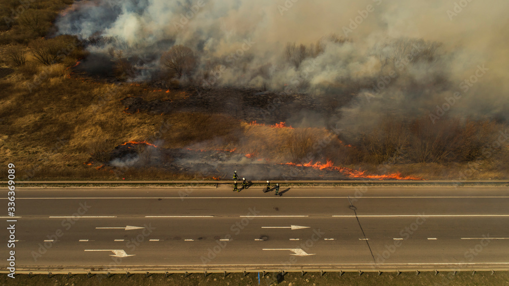 Obraz premium Ukraine, Rivne, 04.04.2020, Massive Fire, Dry Grass Lanes in Fire, Firefighters at Work, Disaster, Ecological Catastrophe