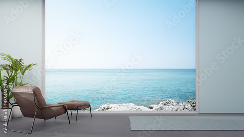 Armchair on concrete floor of large living room in modern house or luxury hotel. Minimal home interior 3d rendering with sky and sea view.