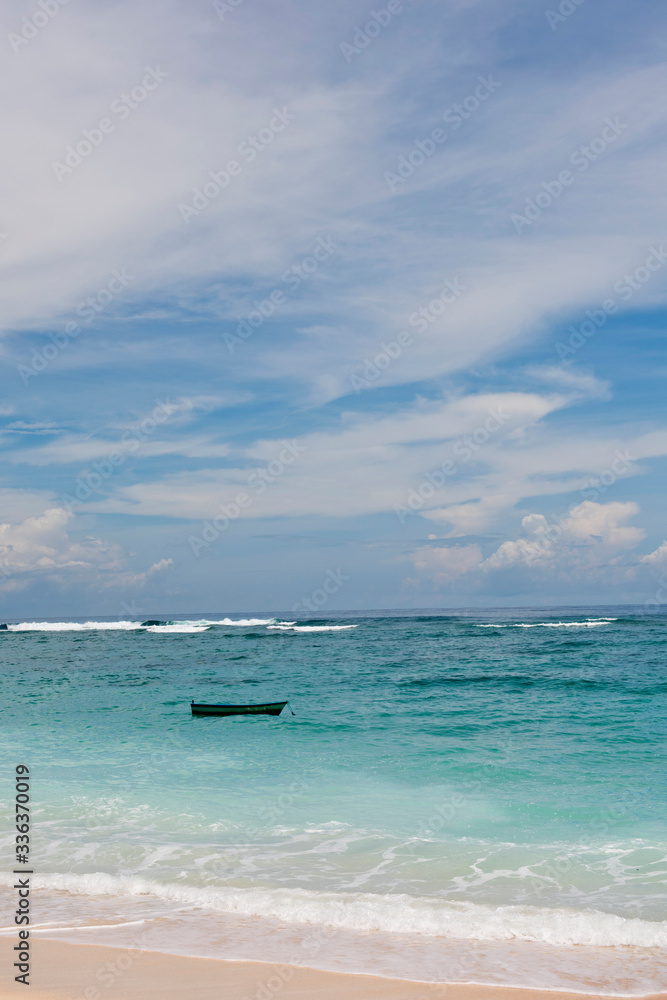 A fishing boat anchored in a deserted lagoon in Bali, Indonesia.