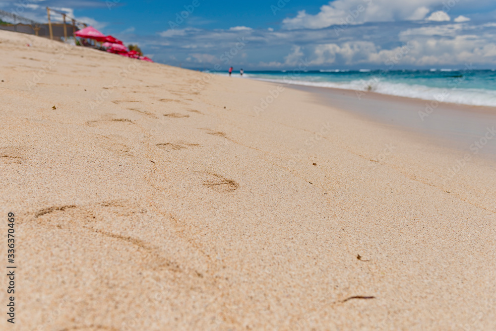 Footprints on the sand in the Pandawa beach. Bali, Indonesia.