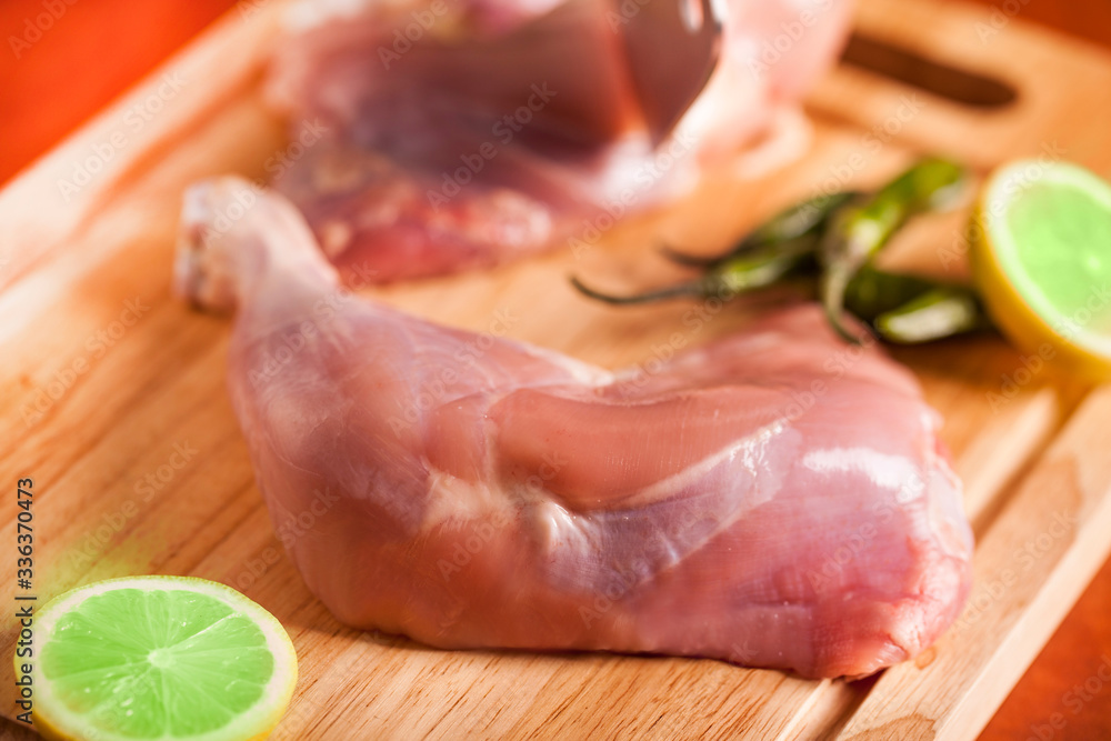 A slice of chicken leg with lemon and peppers A slice of chicken leg with lemon and peppers